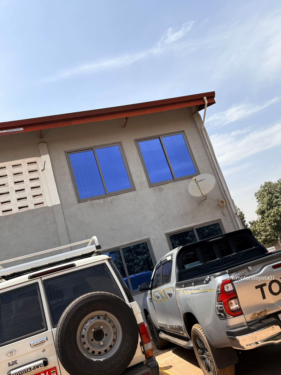 Ansuare Motors office building with Toyota Land Cruiser and Hilux parked outside